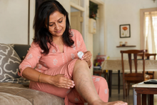 Applying varicose relief balm on lower leg
